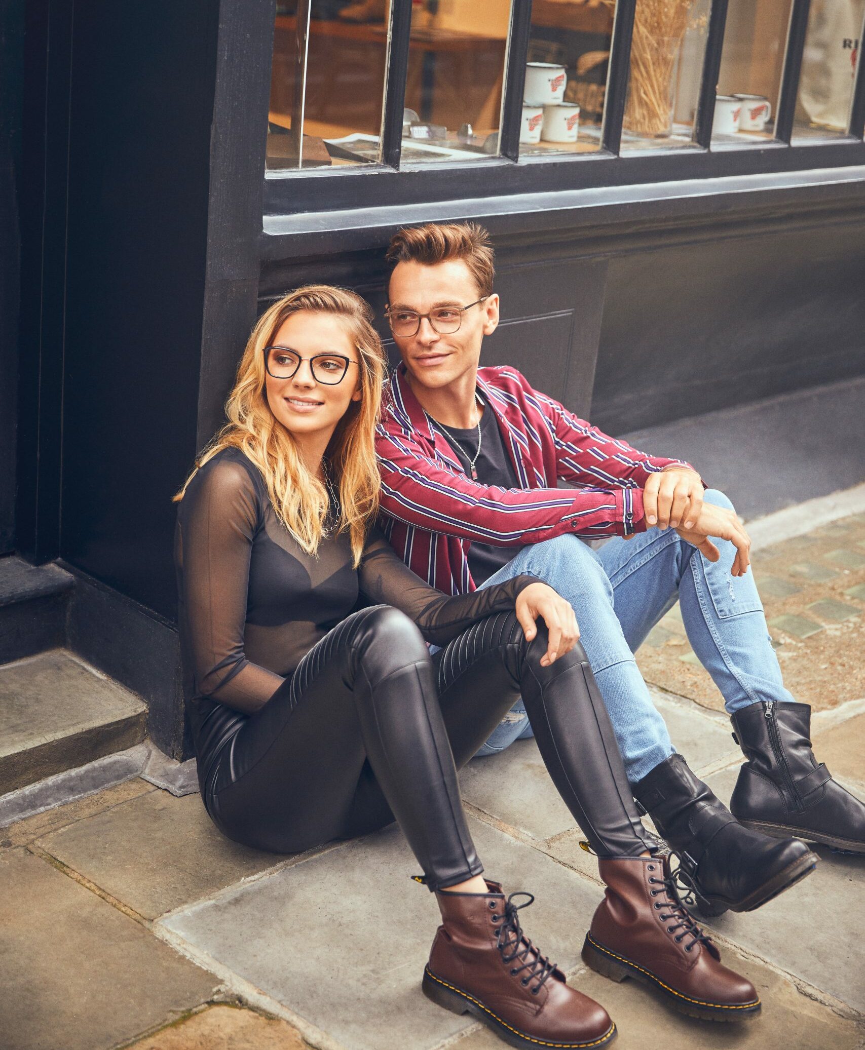 William Morris glasses on female and male models sitting on ground